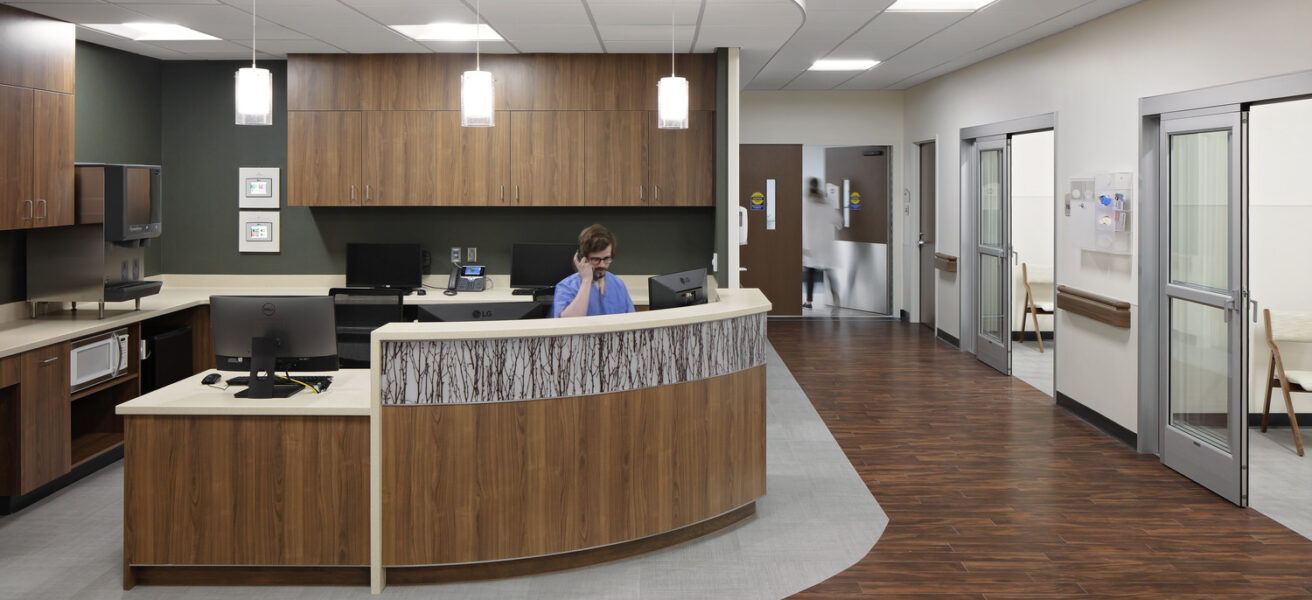 A nurse sits at the nurse station in the surgery department of JCRHC.