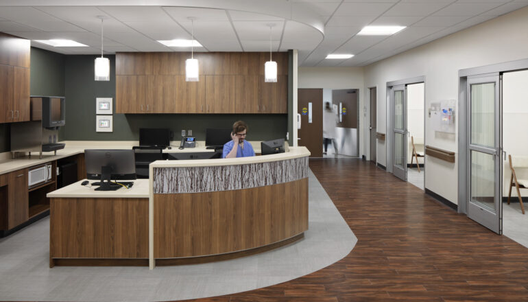 A nurse sits at the nurse station in the surgery department of JCRHC.