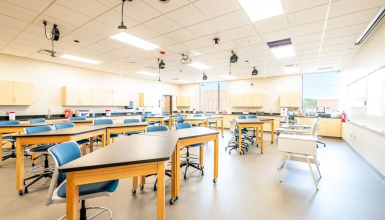 An active learning classroom with flexible seating options and perimeter sink spaces.