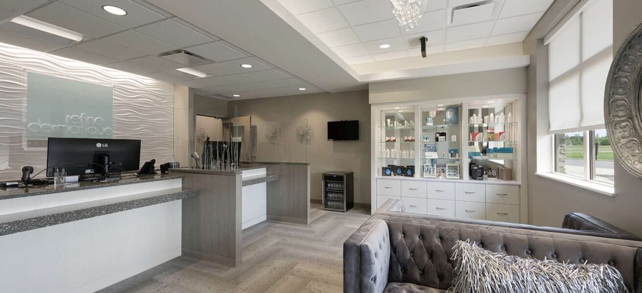 The luxurious waiting room for the clinic's spa, with glass chandelier and product displays.