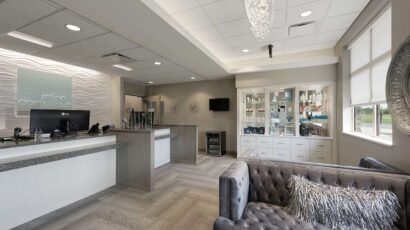 The luxurious waiting room for the clinic's spa, with glass chandelier and product displays.