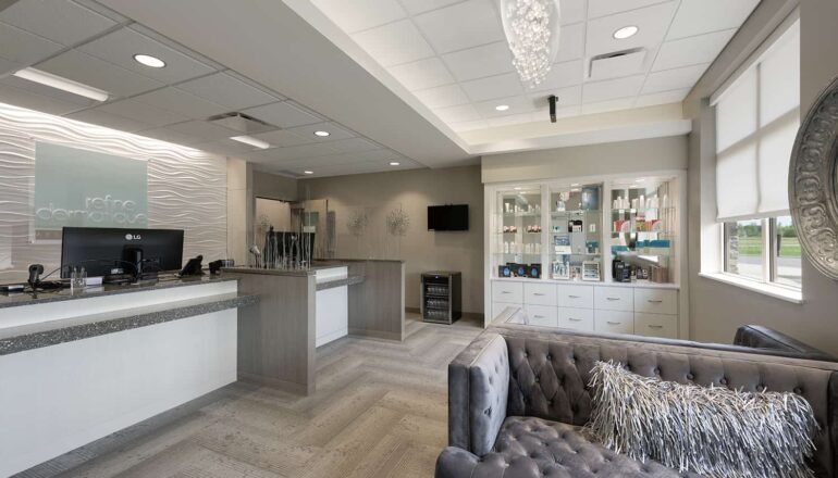 The luxurious waiting room for the clinic's spa, with glass chandelier and product displays.