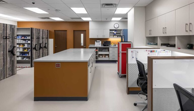The new pharmacy space with rolling storage shelves and staff workstations.