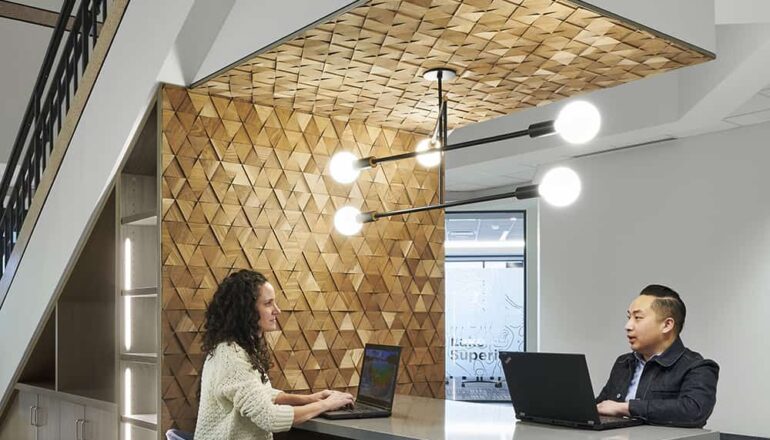 Atrium touchdown workstation with accent wall that matches the reception desk.