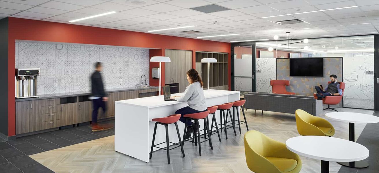 Staff flex space with seating options and branded color wall.