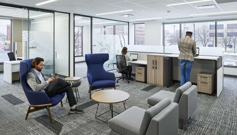 Open touchdown space with blue furniture within an open office environment.