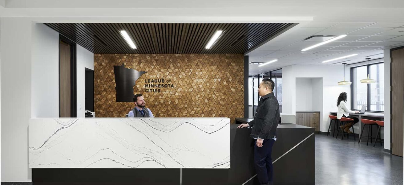 Front reception desk with accent wall and logo.