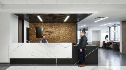 Front reception desk with accent wall and logo.