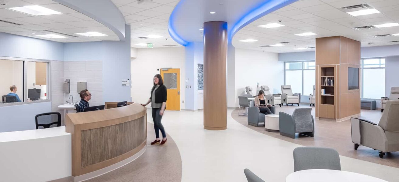 Central nurse station with open access to patient areas and color changing lighting.