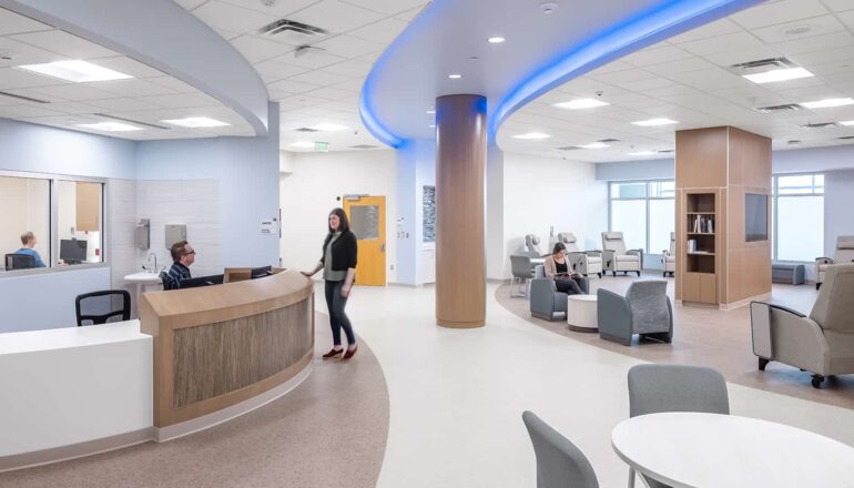 Central nurse station with open access to patient areas and color changing lighting.