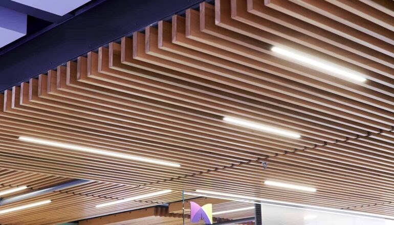Detailed view of wood paneling and lighting on skyway ceiling.