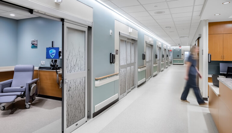 A nurse walks between the pre-post rooms and the nurses station in the MMC Ashland Surgery Center