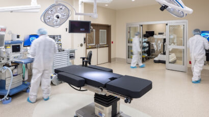 Surgeons work inside the robotic OR in the MMC Ashland Surgery Center. A surgery robot is stored inside a small 