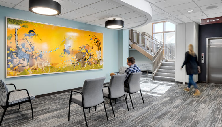 Patients and visitors enter through the main lobby of the surgery center, with a large painting done by a local Native American artist