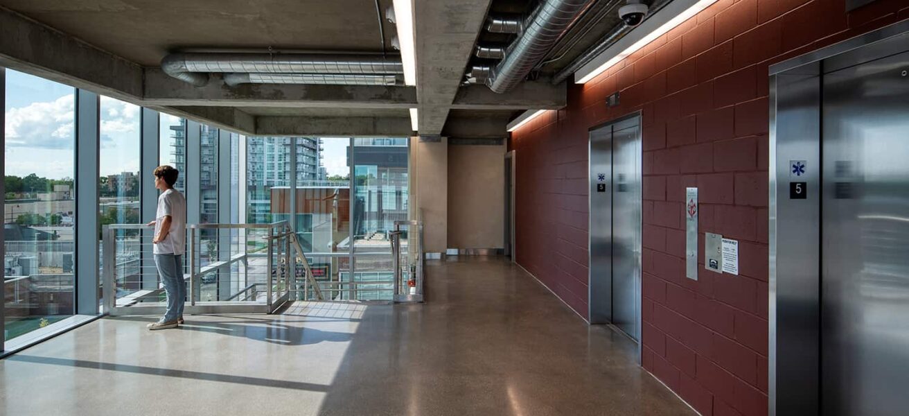 Interior view of pedestrian circulation, elevators, and stairs.