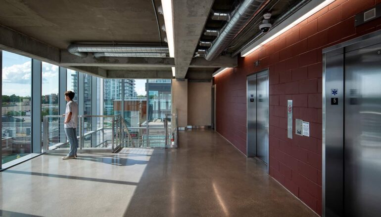 Interior view of pedestrian circulation, elevators, and stairs.