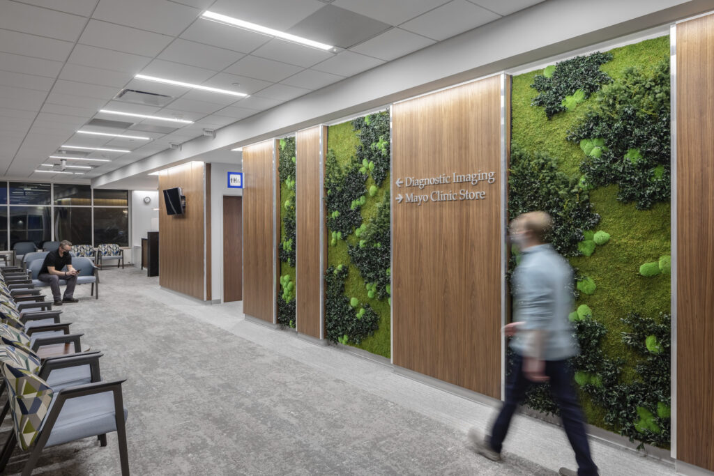 People wait in the Mayo Clinic Health System in Mankato imaging lobby with a green wall.