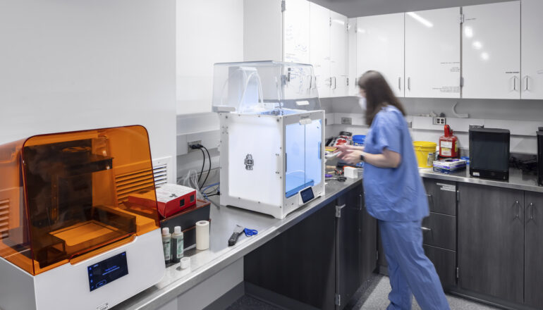 A person uses a 3D printer in the Mayo Clinic simulation space.