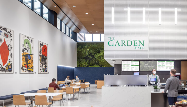 People eat in the Mayo Clinic food court known as the Garden Cafe. The double height space features clerestory windows and was formerly an outdoor courtyard