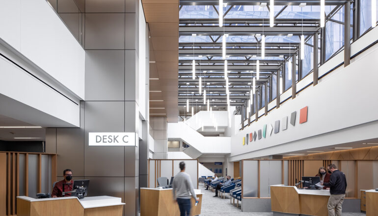 Patients check in for their appointments at the Hilton Atrium Desk C. Several check-in stations ease patient flow and wide open spaces with overhead skylights welcome people into the waiting area