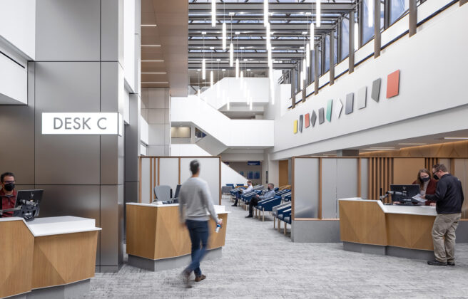 Patients check in for their appointments at the Hilton Atrium Desk C. Several check-in stations ease patient flow and wide open spaces with overhead skylights welcome people into the waiting area