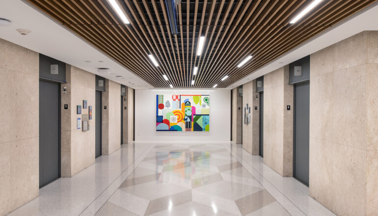 High end finishes lead the way through an elevator lobby to a colorful piece of abstract art in the Mayo Clinic pedestrian subway