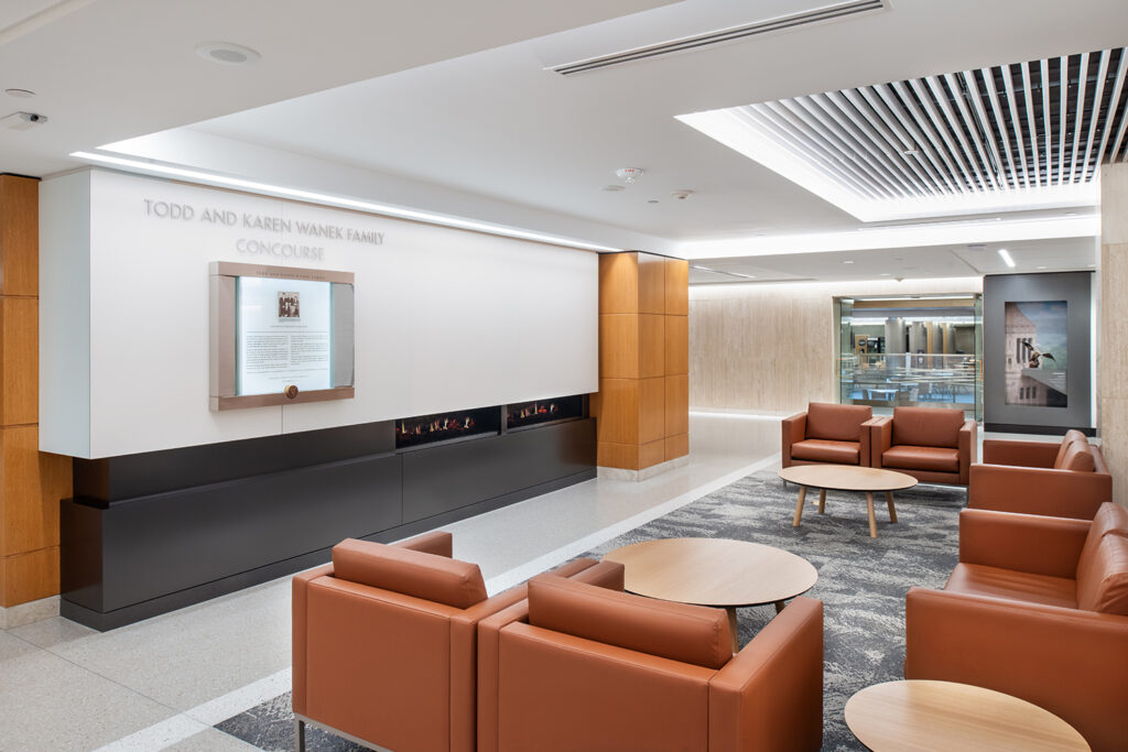 Comfortable leather seating and a small fireplace create a homelike feeling in the Wanek Family Concourse