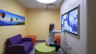 A person does a calming exercise on a touchscreen in a Mayo Clinic psych department sensory room.