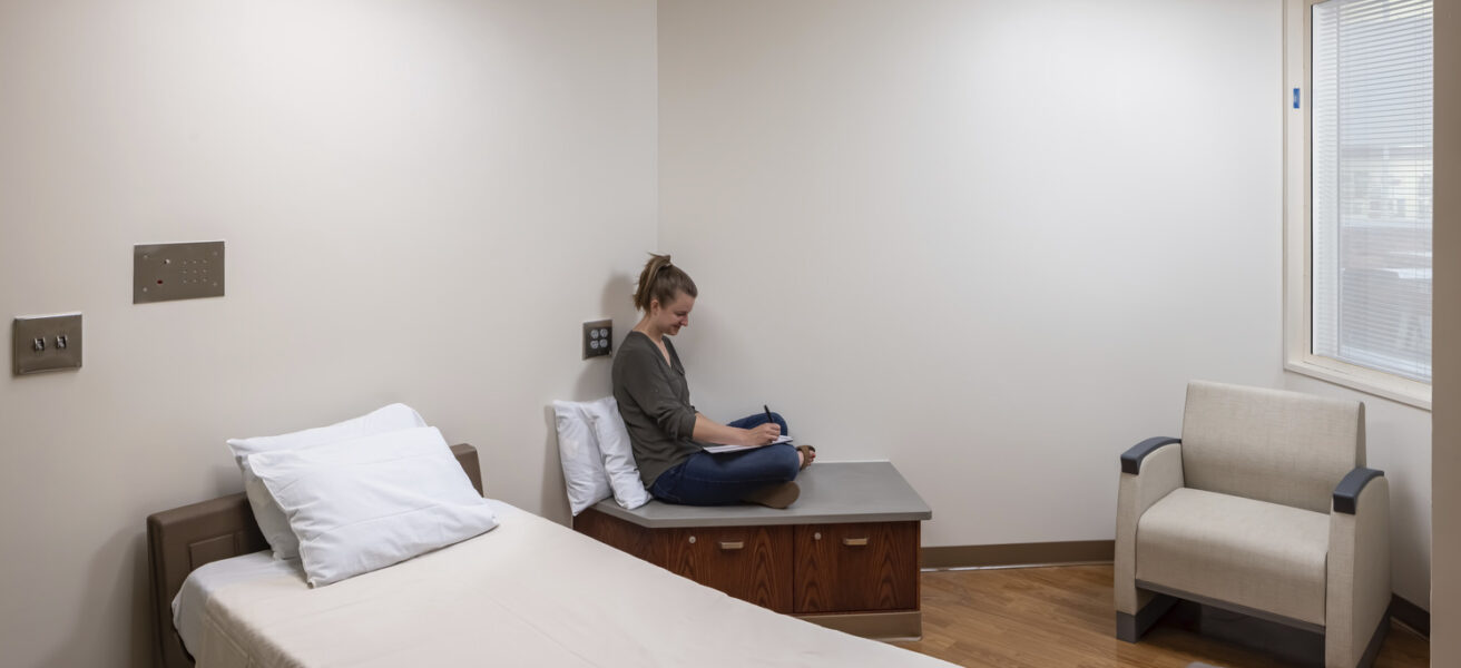 A person reads in one of the Mayo Clinic psych department bedrooms.