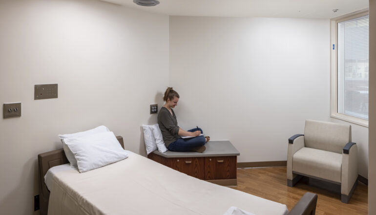 A person reads in one of the Mayo Clinic psych department bedrooms.