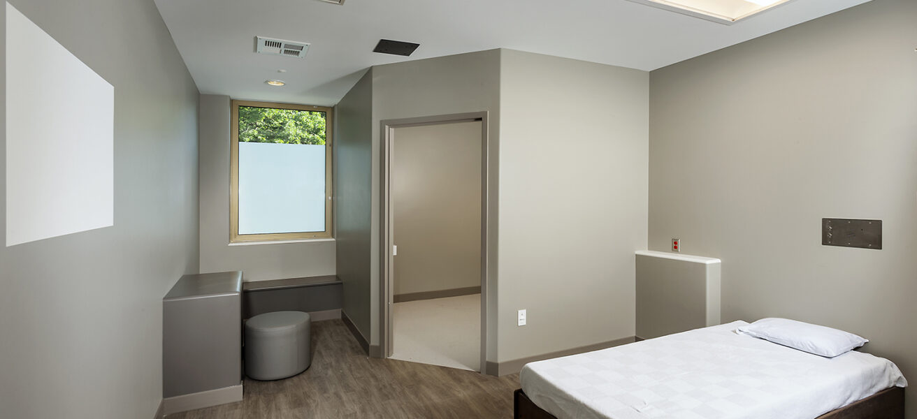 A standard private patient room with one bed and one bathroom in the behavioral health unit