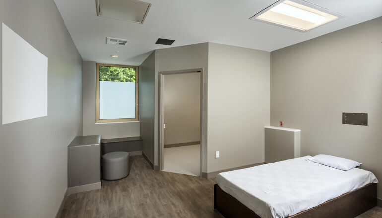 A standard private patient room with one bed and one bathroom in the behavioral health unit