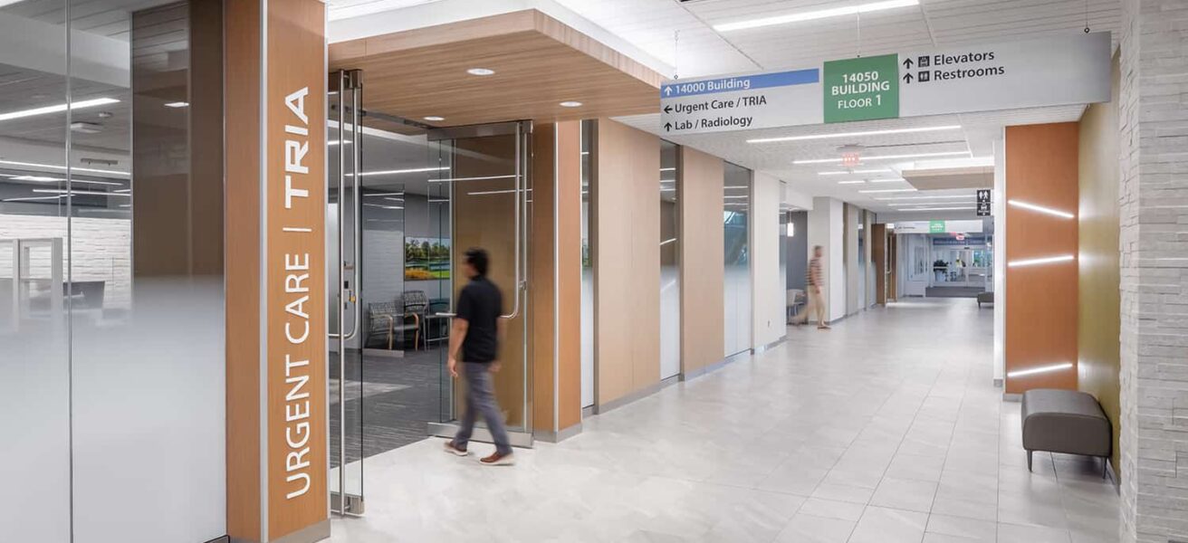 Interior corridor leading to Tria Urgent Care and additional services.