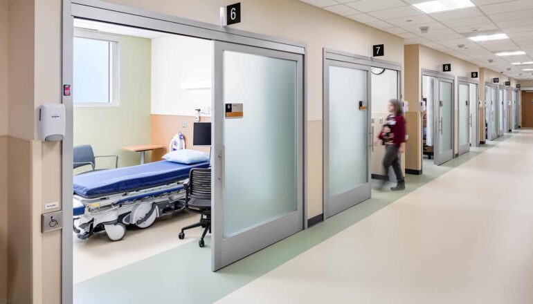 The pre-/post-surgery corridor with sliding opaque doors and soothing color palette.