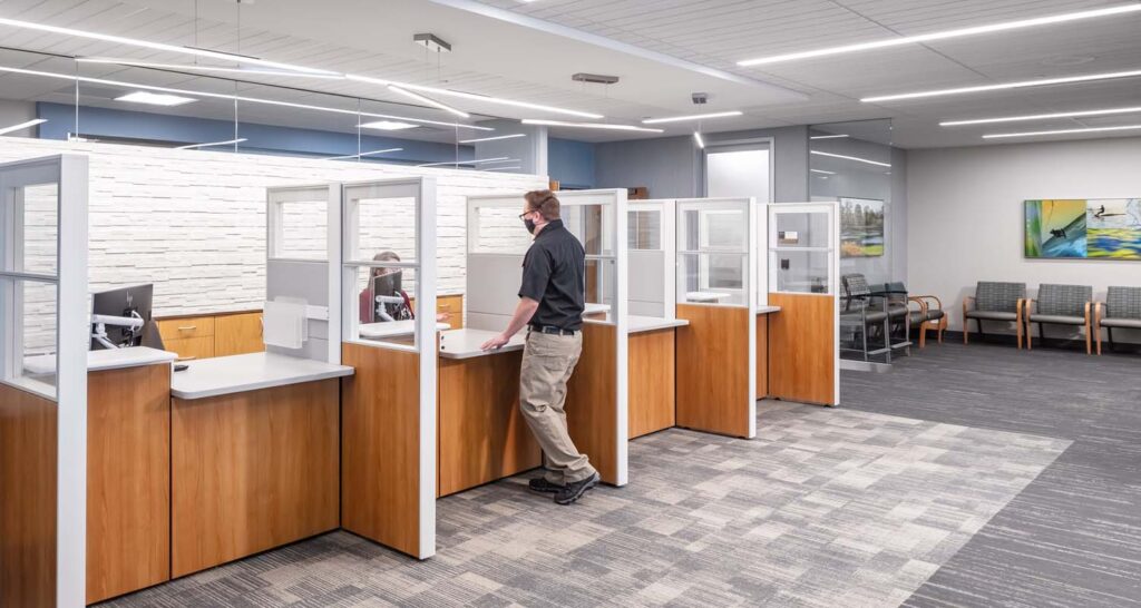 Clinic registration desks with wood paneling and calming gray and blue color palette.