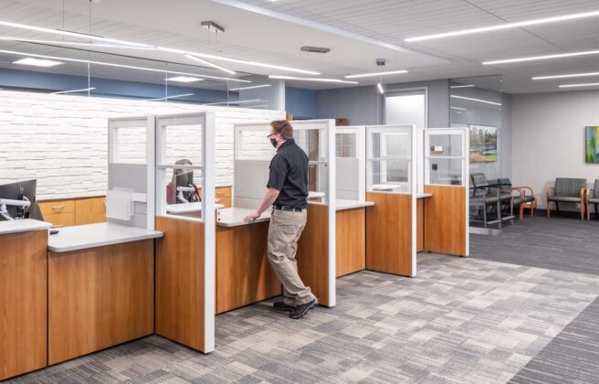 Clinic registration desks with wood paneling and calming gray and blue color palette.