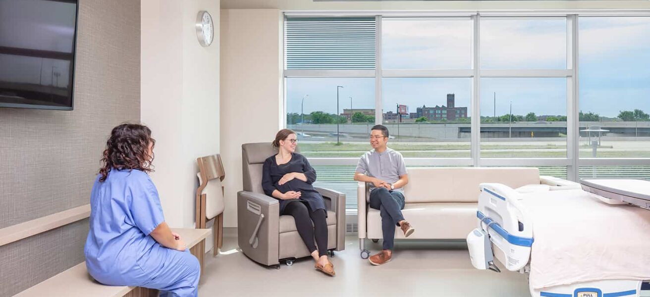 A family enjoying the seating space in a post op room.