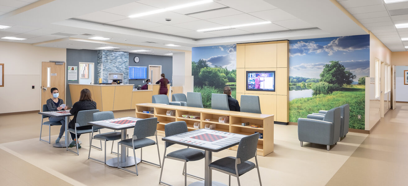 The main lobby of the Regions Inpatient Mental Health Center third floor features a nurse station, game tables, and a large TV