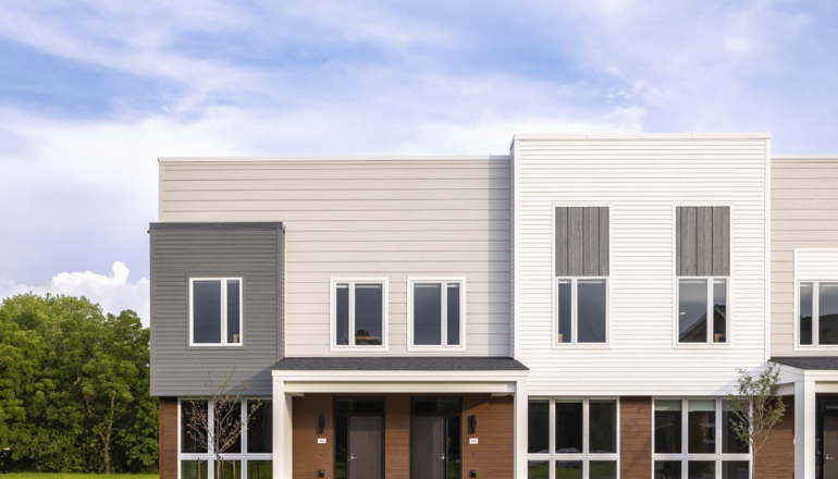 An exterior, head-on view of the Seton Townhome front entries in the Flynntown Village