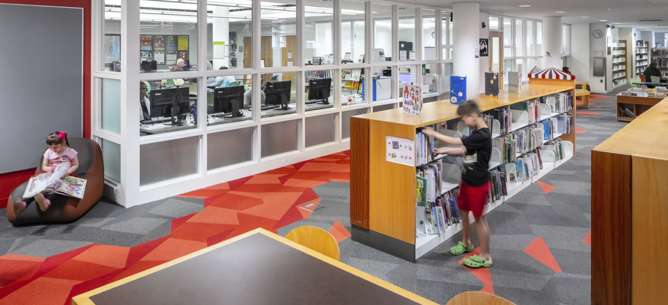 Children read in the children's section of the Rondo Library.