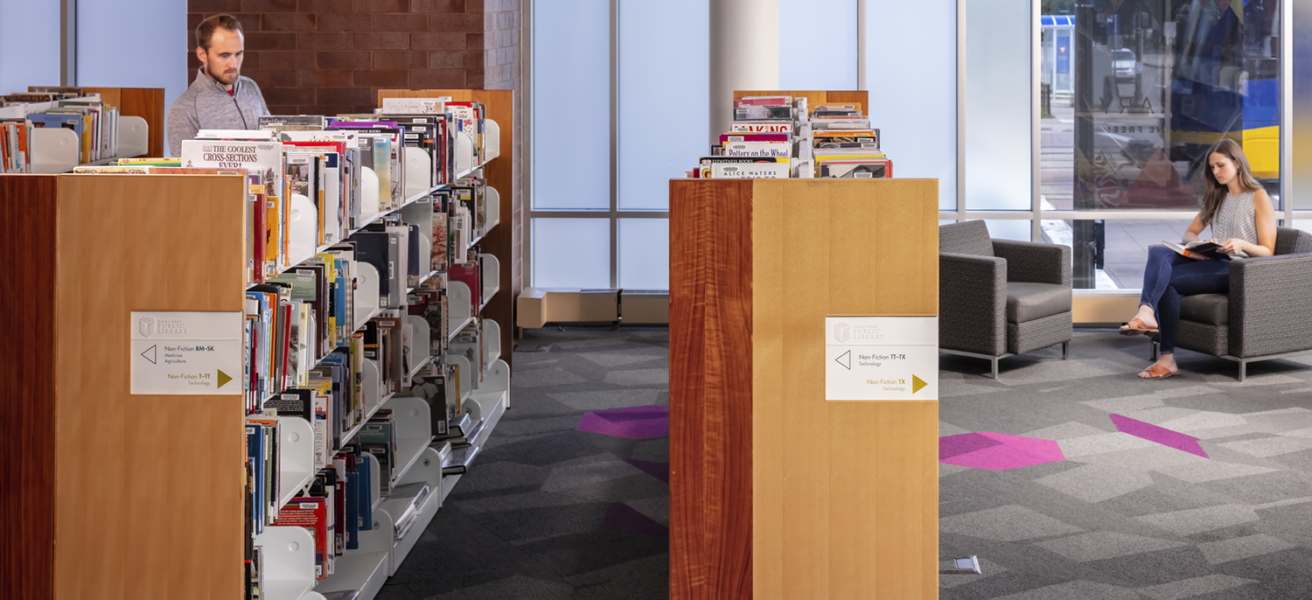 People browse the non-fiction section of the Rondo Library.