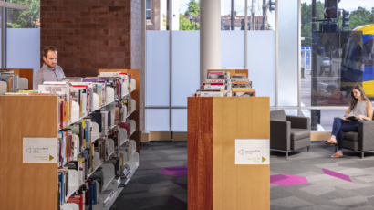 People browse the non-fiction section of the Rondo Library.