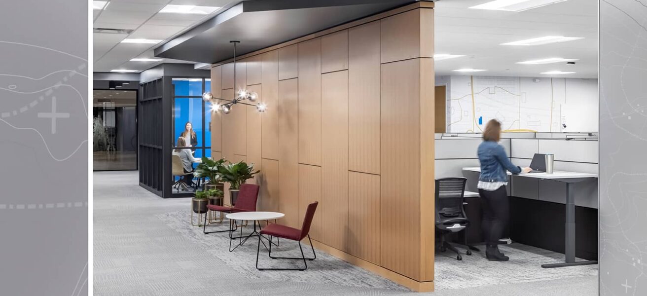 A corridor view from private workstations to shared conference rooms.