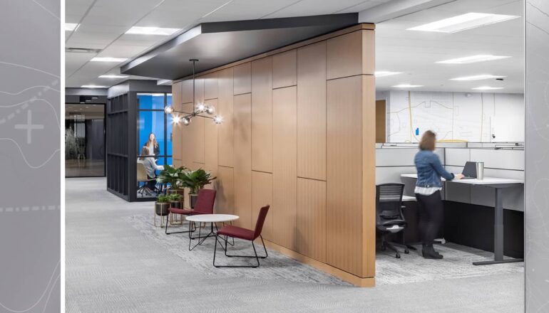 A corridor view from private workstations to shared conference rooms.