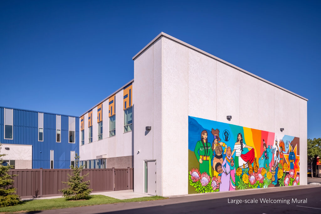 View to the side and back of the social services headquarters featuring a colorful neighborhood mural.