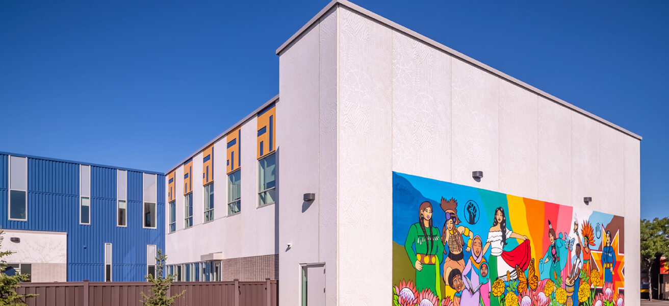 View to the side and back of the social services headquarters featuring a colorful neighborhood mural.