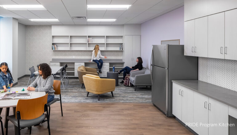 People sitting and eating in the PRIDE program kitchen.