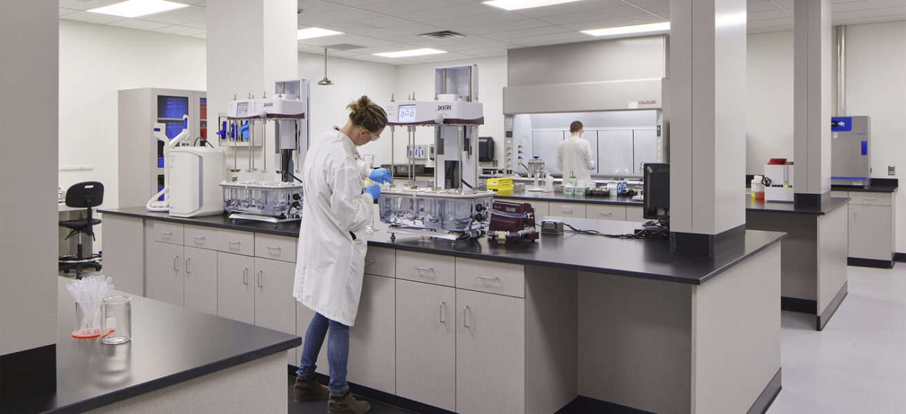 A person performs tests in a Tapemark cleanroom.