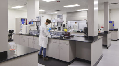 A person performs tests in a Tapemark cleanroom.
