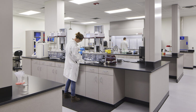 A person performs tests in a Tapemark cleanroom.